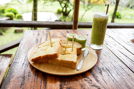 Iced green tea with bread and streamed custardの写真素材