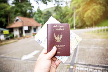 hand hold Thailand passport and Map on blurred background.の写真素材