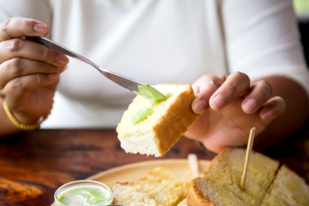 Woman hand with Bread and streamed custardの写真素材