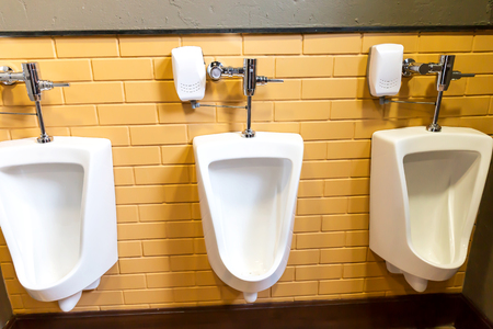 Close up row of urinals men public toiletの写真素材