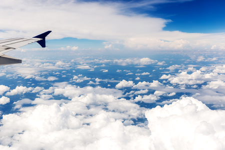 Looking through window aircraft during flight in wing with a blue skyの写真素材