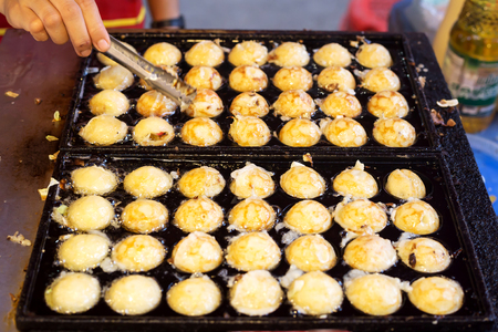 Cooking takoyaki on hot pan famous food japan street foodの写真素材