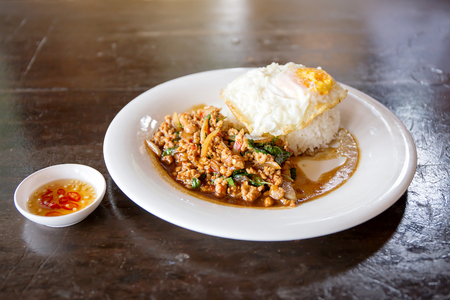 Rice topped with stir-fried minced pork and basil with Fried eggの写真素材