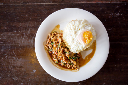 Rice topped with stir-fried minced pork and basil with Fried eggの写真素材