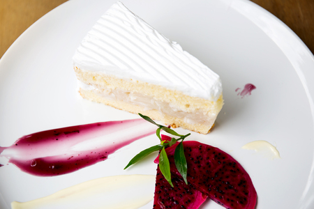 Coconut cake on white plate on tableの写真素材