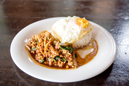 Rice topped with stir-fried minced pork and basil with Fried eggの写真素材