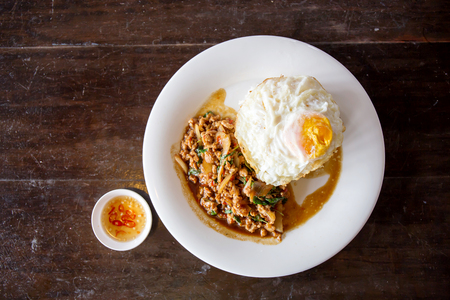 Rice topped with stir-fried minced pork and basil with Fried eggの写真素材