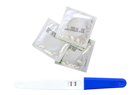Pregnancy test and condom isolated on white backgroundの写真素材