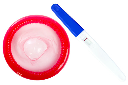 Pregnancy test and condom isolated on white backgroundの写真素材