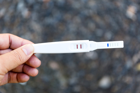 Man holding pregnancy test, New life and new family conceptの写真素材