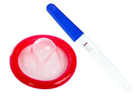 Pregnancy test and condom isolated on white backgroundの写真素材