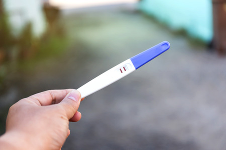Man holding pregnancy test, New life and new family conceptの写真素材