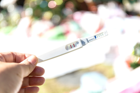 Man holding pregnancy test, New life and new family conceptの写真素材