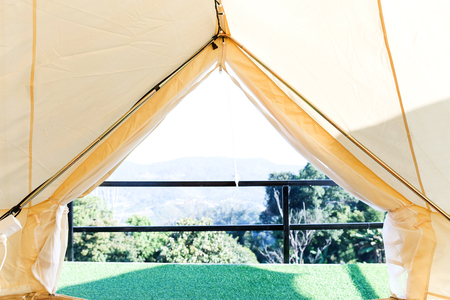 View from the canvas tent upon the green meadow with treesの写真素材