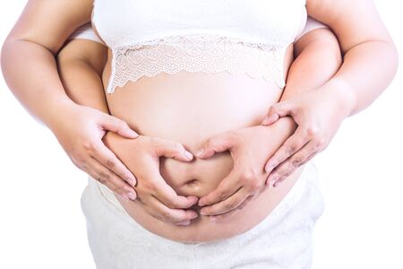 Asian young pregnant couple on the white background.の写真素材