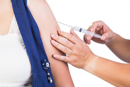 Pregnant woman and injection needle isolated on white backgroundの写真素材