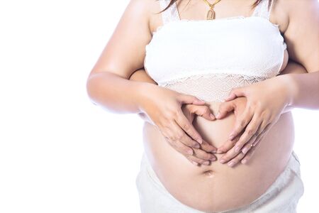 Asian young pregnant couple on the white background.の写真素材