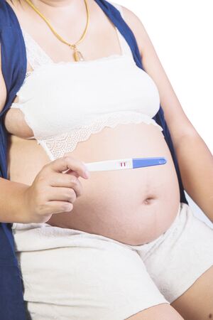 Pregnant woman and Pregnancy check sheet isolated on white backgroundの写真素材