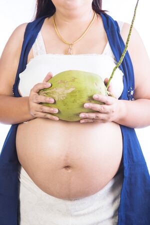 Pregnant woman and coconut isolated on whiteの写真素材
