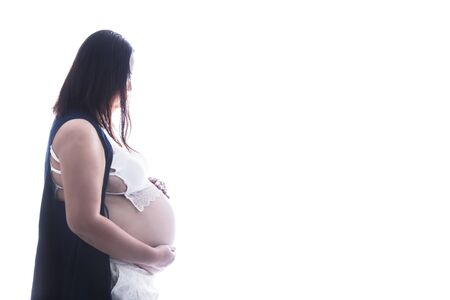 Pregnant Woman touching her belly pregnant middle aged mother's hands caressing her tummy isolated on white backgroundの写真素材