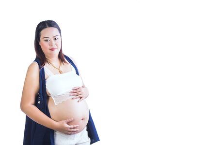 Pregnant Woman touching her belly pregnant middle aged mother's hands caressing her tummy isolated on white backgroundの写真素材