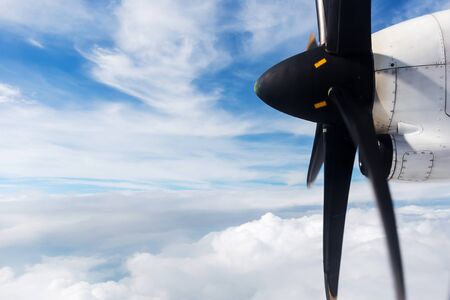 The engine of the plane against blue cloudy sky Skies above and below View from Window の写真素材