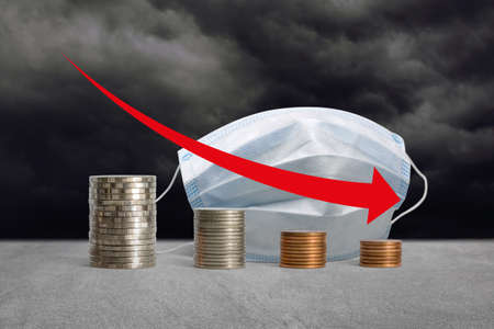 Stacks of coins in a decrease financial from COVID-19 crisis.の写真素材