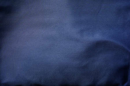 Surface of dark navy blue fabric for background.