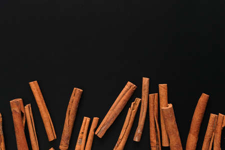 Top view of cinnamon stick on black woodenの写真素材