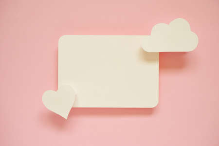 Greeting card ideas for valentine's day with paper cut in the shape of heart placed on pink pastel...
