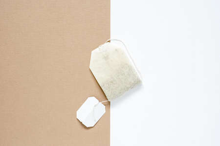 top view of dried tea bag placed on white paper and brown paper, copy space concept.の写真素材