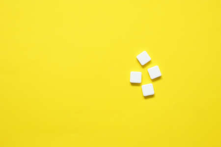 top view of white pills on yellow background.の写真素材