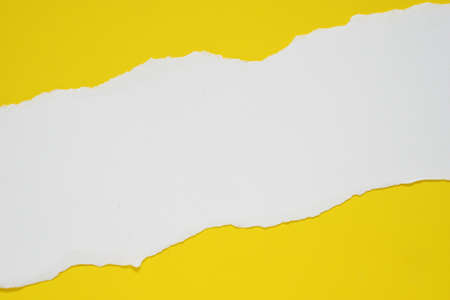 abstract background with ripped blank white paper on yellow background.の写真素材