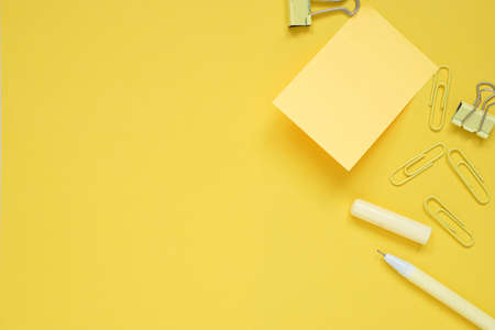 yellow note pad stick on yellow paper  and yellow stationery equipment  , copy space.の写真素材