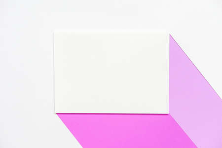 blank clean white mock up brochure with two colors of purple paper against white paper background, top view, flat lay.の写真素材