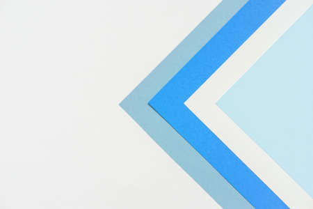 On a white background, an abstract background concept with a geometric pattern in various hues of blue paper and white paper stacking.の写真素材