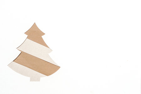 Background concept for Christmas , On a white background,  paper cut into the shape of a Christmas tree with copy space.の写真素材
