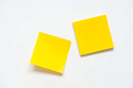 blank yellow notepad sheet on white background.の写真素材