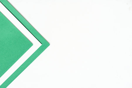 On a blank white background with soft shadow and copy space, white paper and dark green paper is layered in geometric forms.の写真素材