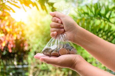 Woman showing money in bagの写真素材