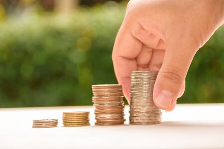 Woman putting coins on stack