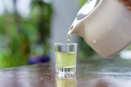 Pouring hot green teaの写真素材