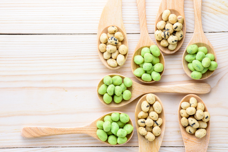 Coated peanuts seaweed and wasabi flavor in wood spoon on wooden tableの写真素材