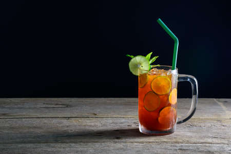 A glass of ice lemon tea on wooden tableの写真素材