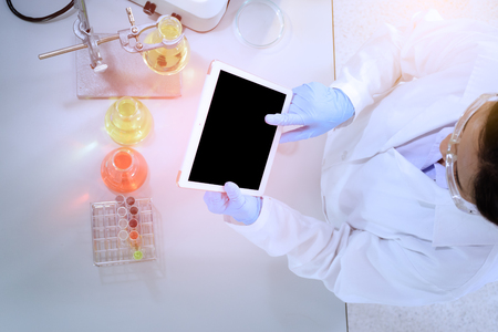Scientist with tablet computer in hand working science laboratoryの写真素材