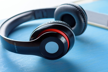 Wireless headphone on blue wooden table