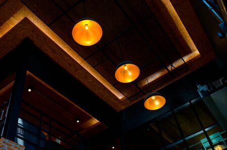 Vintage style light bulb hanging on ceiling in coffee shop