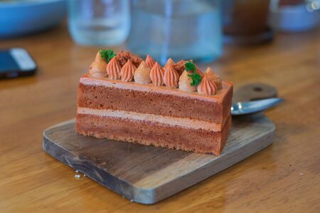 Homemade Thai tea cake on wooden plate