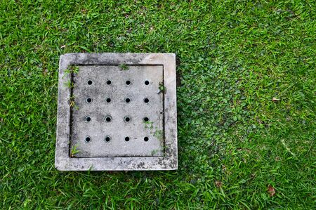 Manhole cover in the lawnの写真素材