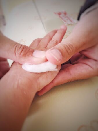 Nurse removed saline needle and use cotton for stop the bleeding (blur)の写真素材